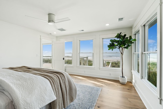 313 E Arctic Ave, Folly Beach, SC 29439 - bedroom with light wood-style flooring, multiple windows, baseboards, ceiling fan, and recessed lighting