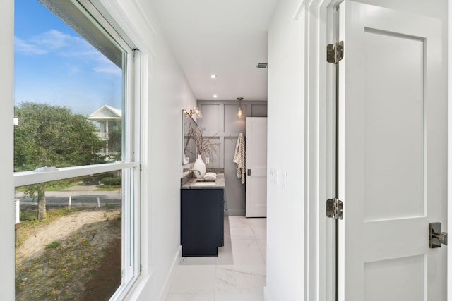 313 E Arctic Ave, Folly Beach, SC 29439 - hallway with light marble finish floors, baseboards, and recessed lighting