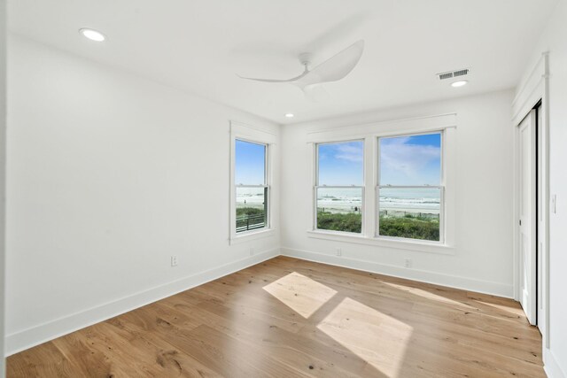 313 E Arctic Ave, Folly Beach, SC 29439 - unfurnished bedroom with baseboards, light wood-type flooring, a ceiling fan, and recessed lighting