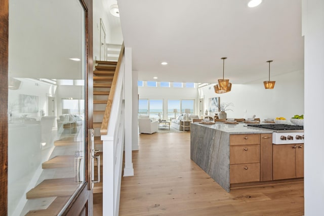 313 E Arctic Ave, Folly Beach, SC 29439 - kitchen with stainless steel gas stovetop, light wood-type flooring, hanging light fixtures, open floor plan, and recessed lighting