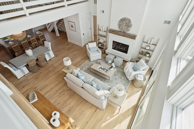 313 E Arctic Ave, Folly Beach, SC 29439 - living area with a high ceiling, a fireplace, healthy amount of natural light, and wood finished floors