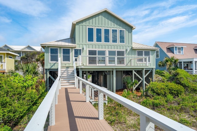 313 E Arctic Ave, Folly Beach, SC 29439 - back of property with board and batten siding, stairway, a standing seam roof, and metal roof