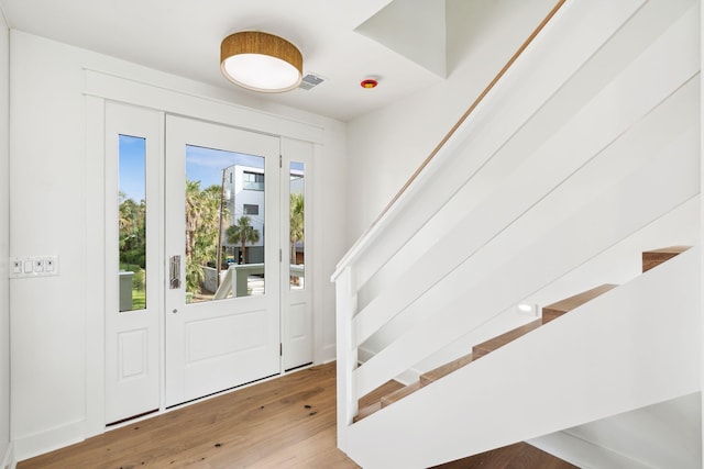 313 E Arctic Ave, Folly Beach, SC 29439 - entryway featuring wood finished floors and stairway