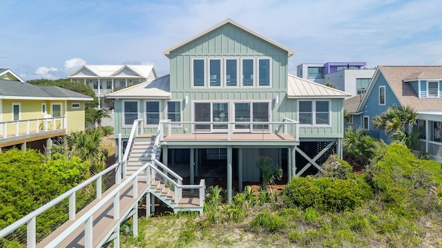 313 E Arctic Ave, Folly Beach, SC 29439 - rear view of property with board and batten siding, a standing seam roof, a deck, and metal roof