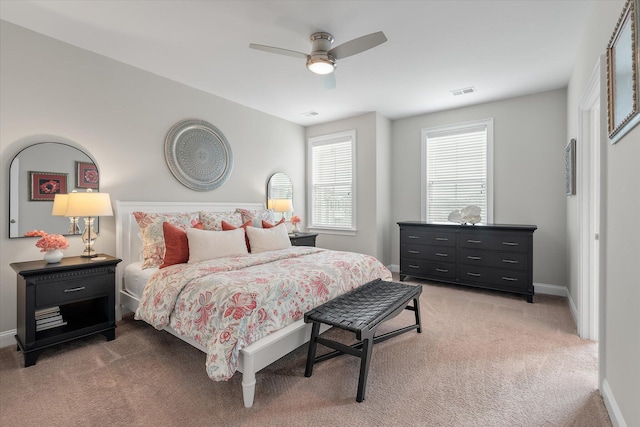 bedroom with carpet floors, visible vents, baseboards, and a ceiling fan