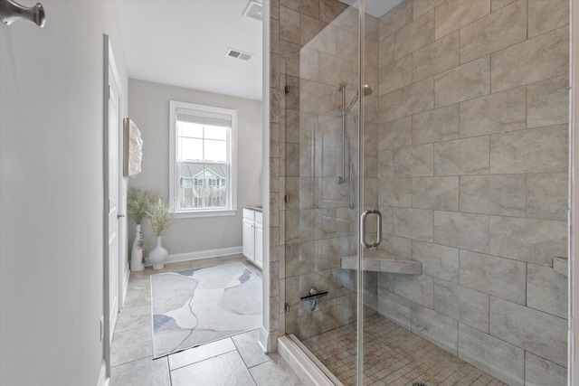 full bathroom featuring a stall shower, visible vents, and baseboards