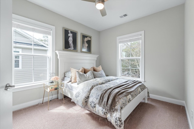 bedroom featuring a ceiling fan, carpet flooring, visible vents, and baseboards