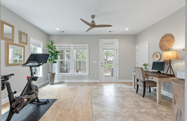 home office with recessed lighting, a wealth of natural light, and baseboards