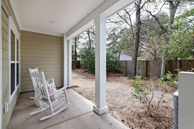 view of patio with a porch and fence