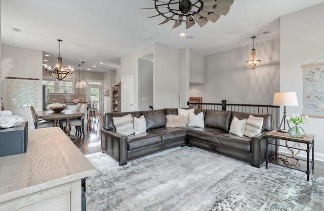 living area featuring baseboards, visible vents, wood finished floors, and recessed lighting