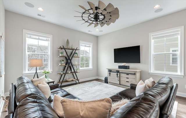 living room featuring visible vents, baseboards, ceiling fan, wood finished floors, and recessed lighting