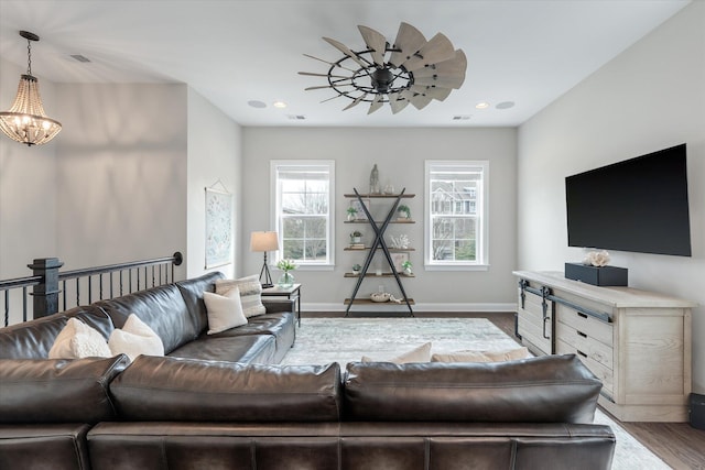 living room featuring baseboards, wood finished floors, and recessed lighting