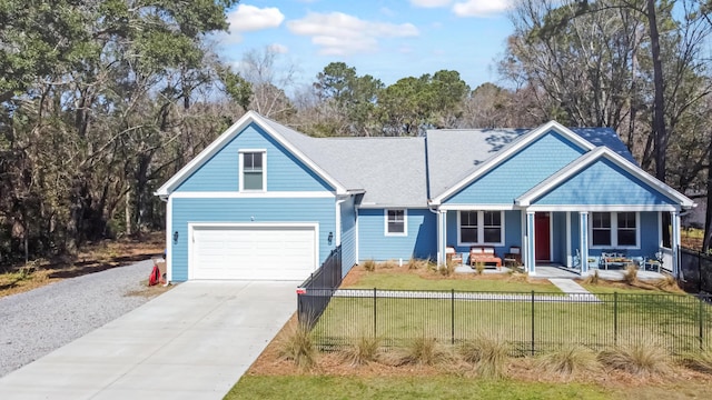 view of front of house with a fenced front yard, a porch, driveway, and a front yard