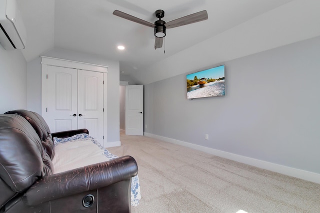 sitting room with a ceiling fan, a wall mounted AC, carpet floors, baseboards, and vaulted ceiling