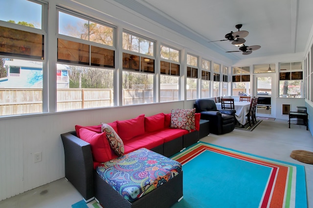 sunroom with a healthy amount of sunlight and ceiling fan