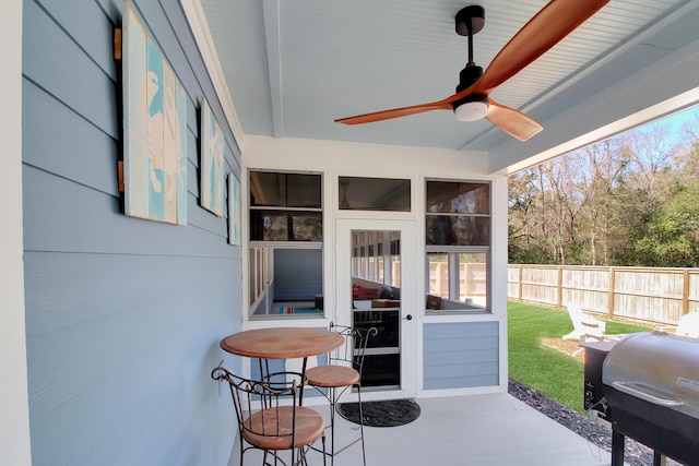 view of patio / terrace with area for grilling, ceiling fan, and fence