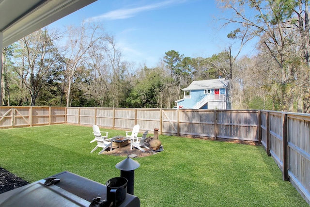 view of yard featuring a fire pit and a fenced backyard