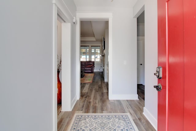 foyer with light wood-type flooring and baseboards