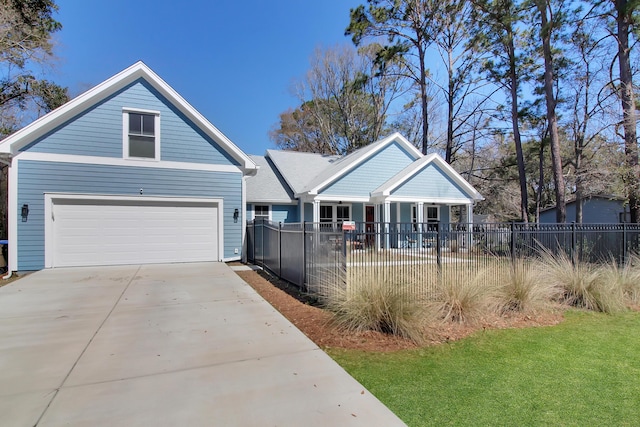 view of front of house featuring fence private yard, a garage, and driveway