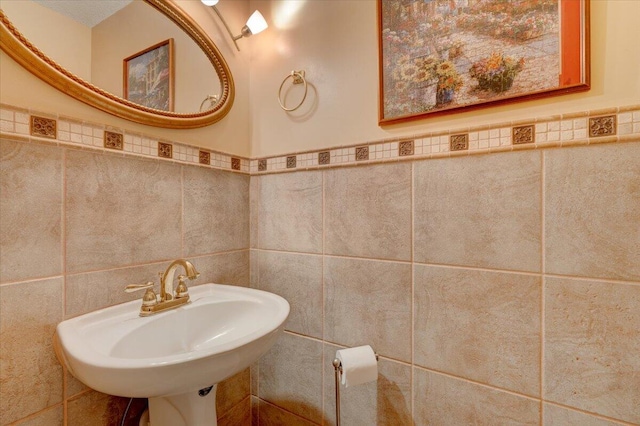 bathroom with tile walls and sink