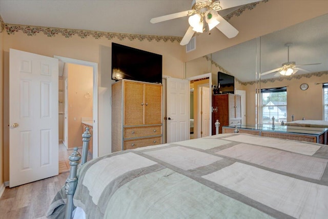 bedroom with ceiling fan, light wood-type flooring, and lofted ceiling