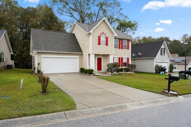 colonial home featuring a garage, central AC unit, and a front yard