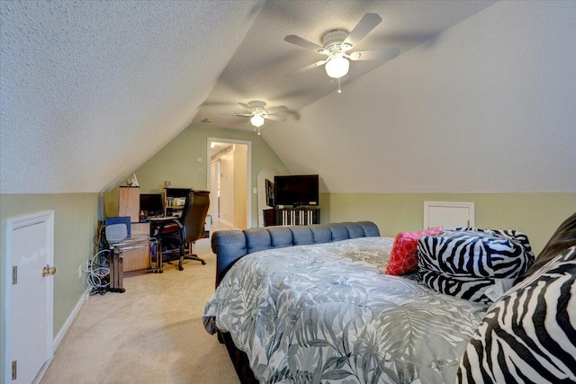 bedroom with a textured ceiling, light colored carpet, lofted ceiling, and ceiling fan