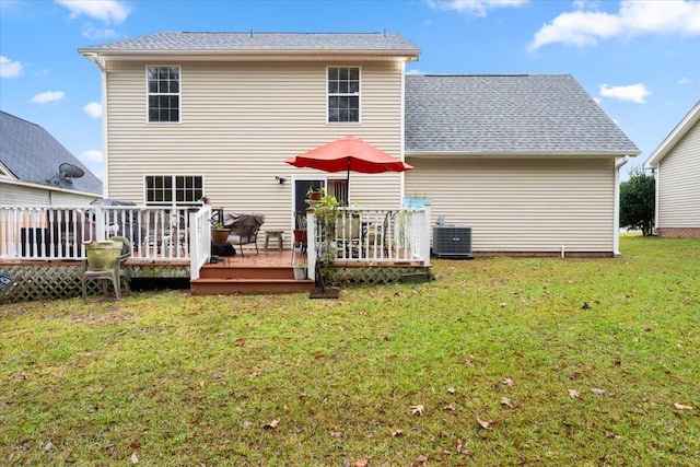 back of house with central air condition unit, a yard, and a deck