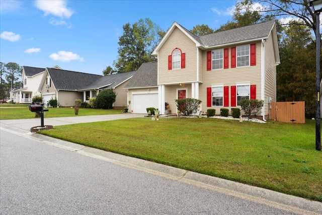 colonial-style house with a garage and a front lawn