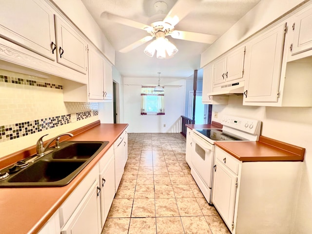 kitchen featuring tasteful backsplash, white cabinetry, under cabinet range hood, electric stove, and a sink