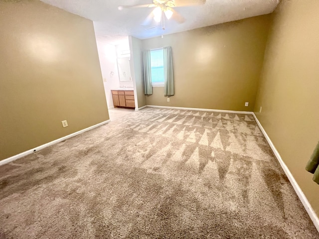 spare room with ceiling fan, baseboards, and carpet floors