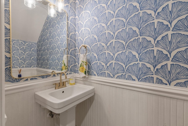 bathroom featuring wainscoting and a sink