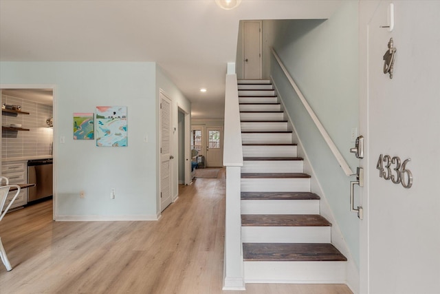 staircase with recessed lighting, wood finished floors, and baseboards