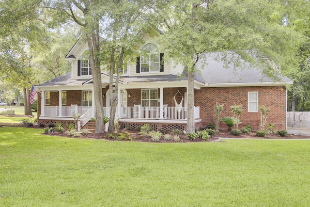 view of front of property with a porch, a front lawn, and brick siding
