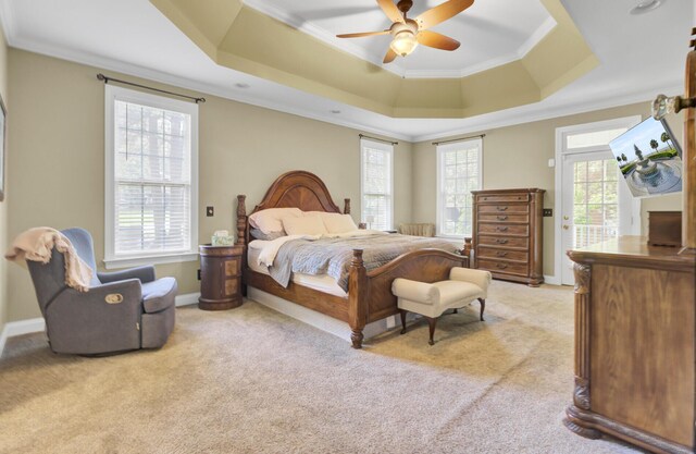 bedroom with crown molding, light colored carpet, a raised ceiling, a ceiling fan, and baseboards
