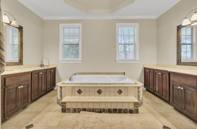 bathroom featuring two vanities, crown molding, tile patterned floors, and a garden tub