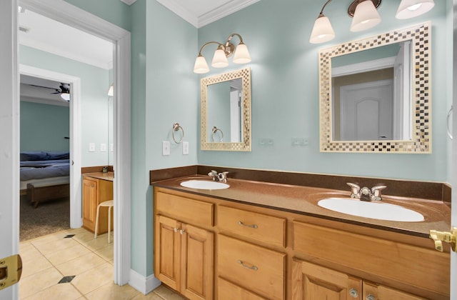 ensuite bathroom featuring ornamental molding, tile patterned flooring, double vanity, baseboards, and ceiling fan