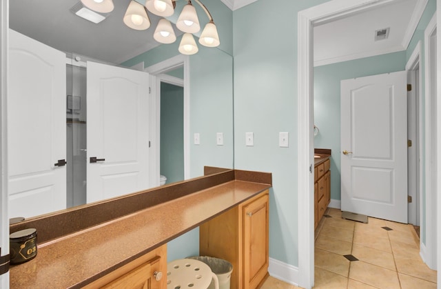 bathroom with vanity, tile patterned floors, baseboards, crown molding, and toilet