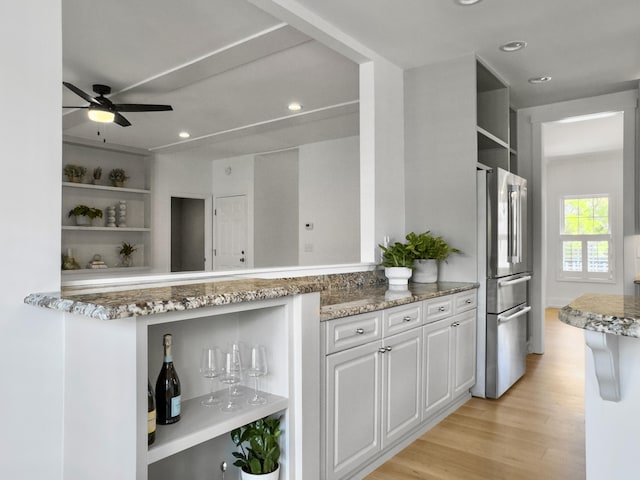 1491 Greenshade Way, Mount Pleasant, SC 29464 - kitchen featuring open shelves, freestanding refrigerator, light stone counters, light wood-style floors, and ceiling fan