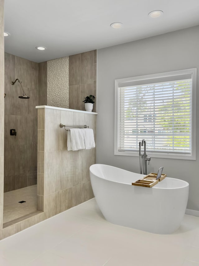 1491 Greenshade Way, Mount Pleasant, SC 29464 - bathroom with a soaking tub, a walk in shower, tile patterned floors, and recessed lighting