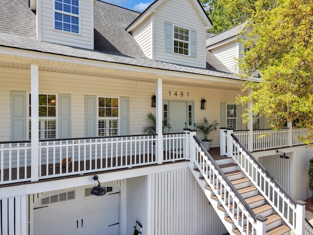 1491 Greenshade Way, Mount Pleasant, SC 29464 - view of front facade with covered porch, stairway, a garage, and roof with shingles