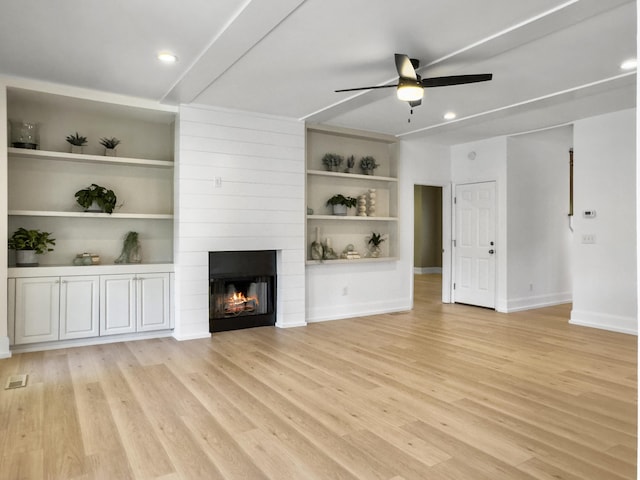 1491 Greenshade Way, Mount Pleasant, SC 29464 - unfurnished living room with ceiling fan, light wood-style flooring, a large fireplace, baseboards, and built in features