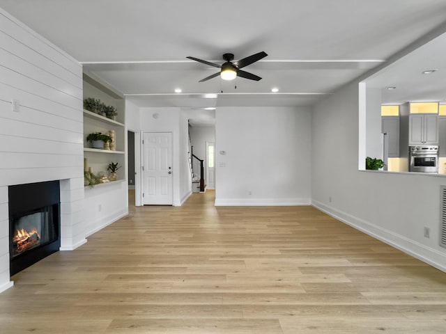 1491 Greenshade Way, Mount Pleasant, SC 29464 - unfurnished living room with ceiling fan, baseboards, a large fireplace, light wood finished floors, and recessed lighting