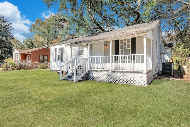 ranch-style home with cooling unit, a porch, and a front yard