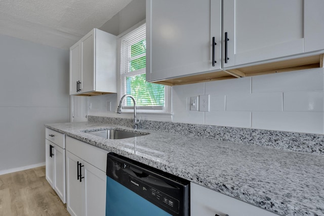 kitchen with white cabinets, a textured ceiling, sink, dishwasher, and light hardwood / wood-style floors