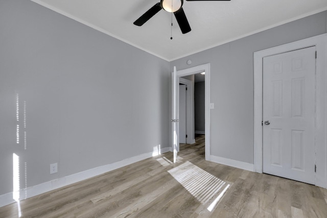 unfurnished bedroom featuring ceiling fan, crown molding, and light hardwood / wood-style flooring