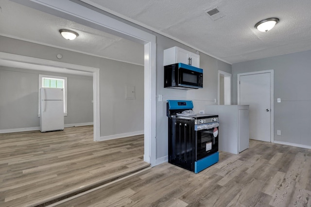 kitchen with white cabinets, black appliances, a textured ceiling, and light hardwood / wood-style floors