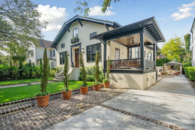 view of front of home with a front yard and stucco siding