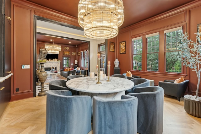 dining space featuring a notable chandelier, crown molding, and a fireplace