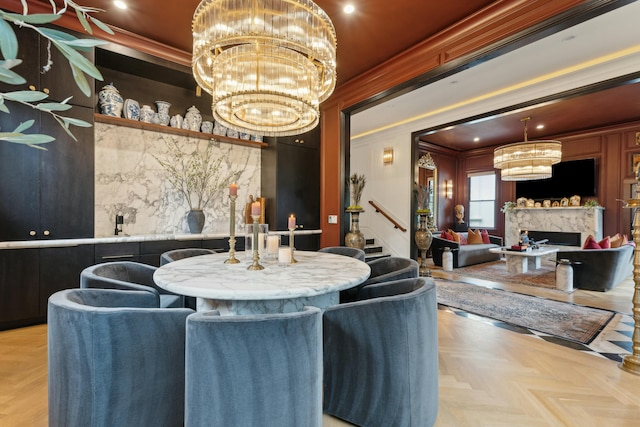 dining space featuring a chandelier, a premium fireplace, stairs, and crown molding